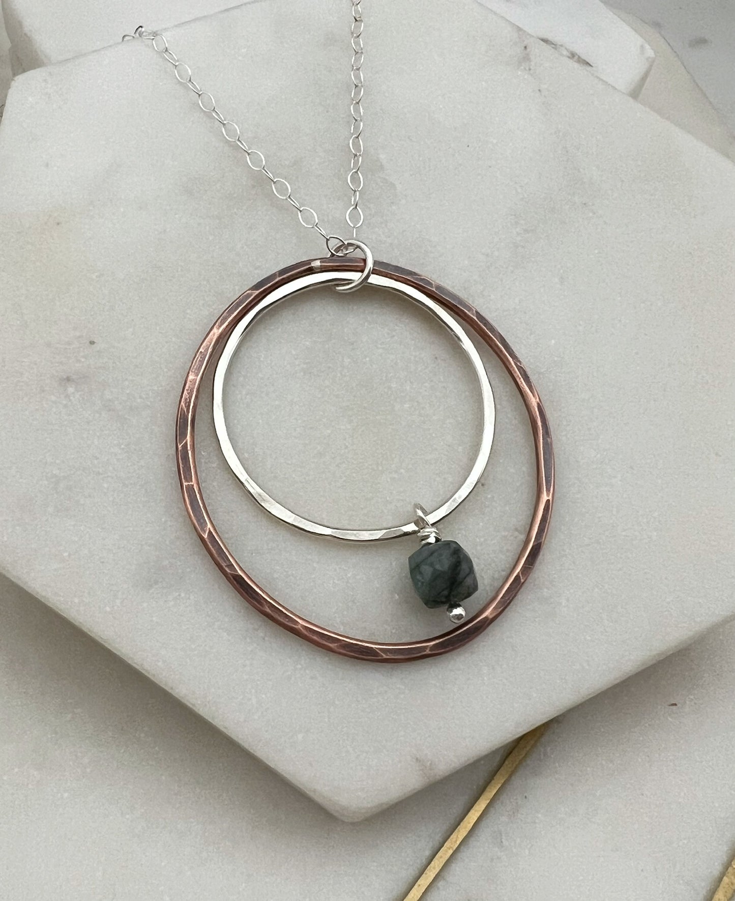 Sterling silver and copper forged hoop necklace with emerald